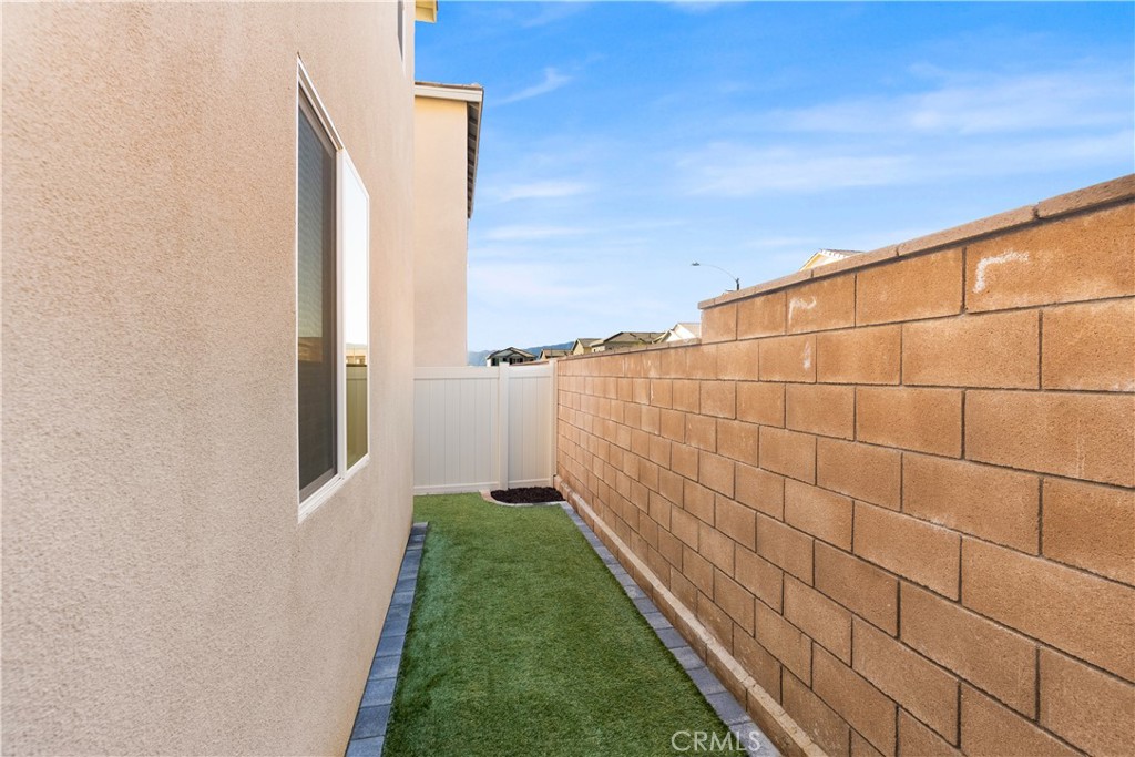 904 Maya Crossing, Unit 19 Lake Elsinore, CA 92530 - Photo 22 of 25 a view of a backyard with pathway