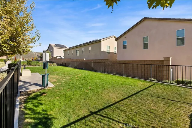 a view of a backyard with wooden fence