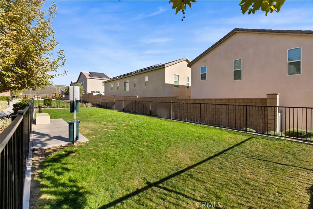 904 Maya Crossing, Unit 19 Lake Elsinore, CA 92530 - Photo 25 of 25 a view of a backyard with wooden fence