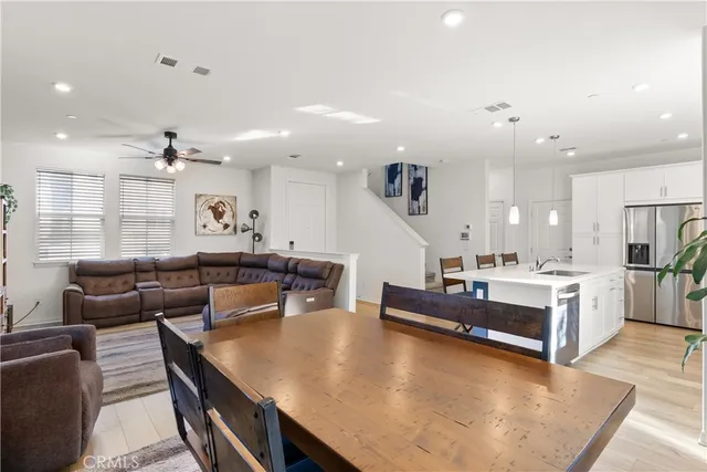 a living room with kitchen island furniture and a wooden floor
