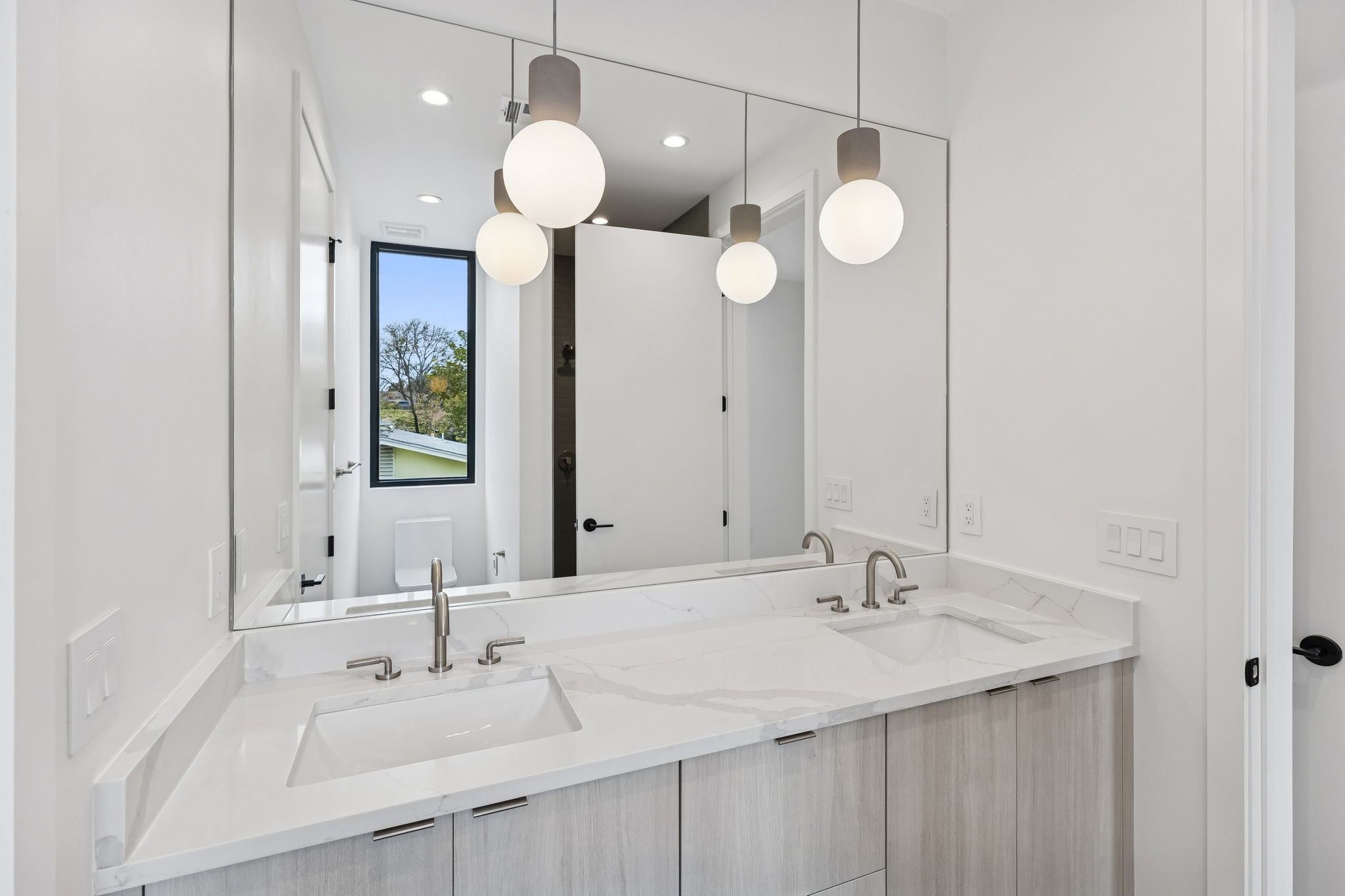 3007 Locke Lane Austin, TX 78704 - Photo 21 of 32 a bathroom with a sink vanity and a mirror