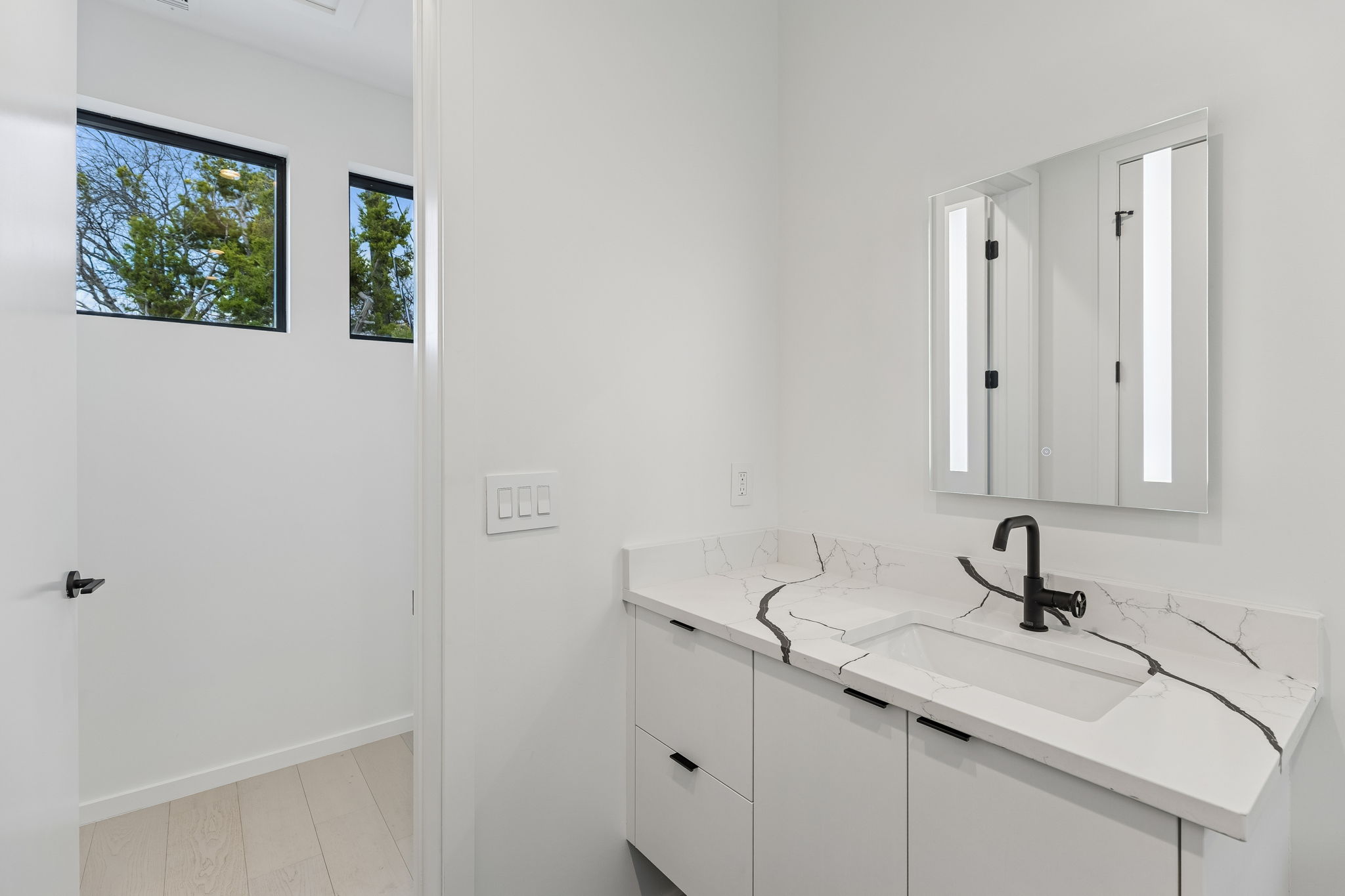 3007 Locke Lane Austin, TX 78704 - Photo 25 of 32 a bathroom with a sink and a window