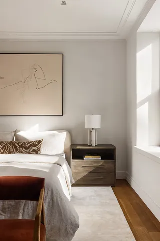 a bed room with a bed and a chair