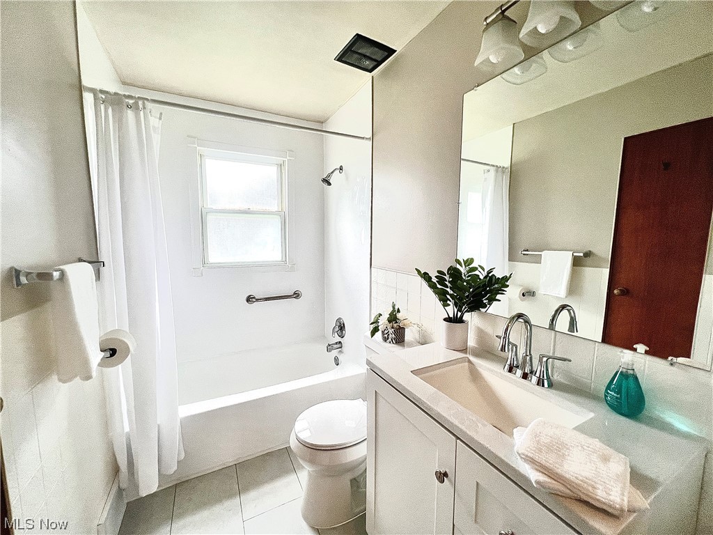 3923 Jaeger Road Lorain, OH 44053 - Photo 13 of 34 Full bathroom featuring shower / tub combo with curtain, vanity, mirror, and light tile floors