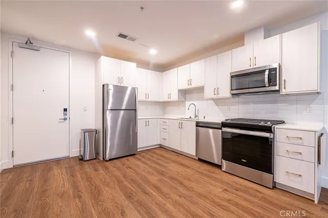 a kitchen with a refrigerator stove and microwave