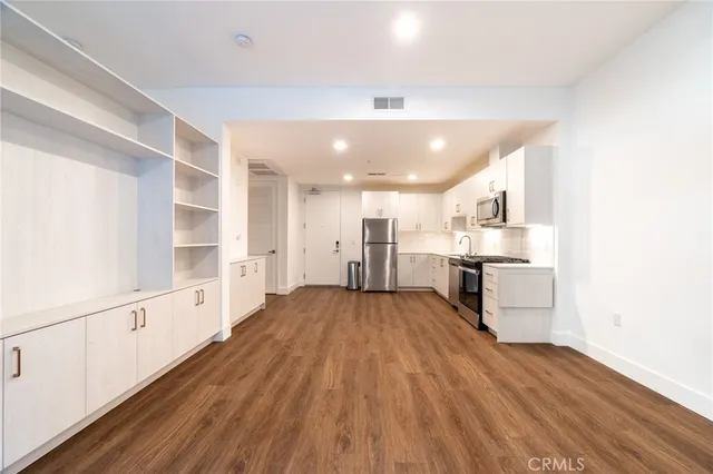 a view of a kitchen with wooden floor