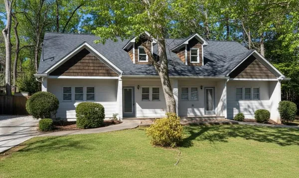 a front view of a house with a yard and porch