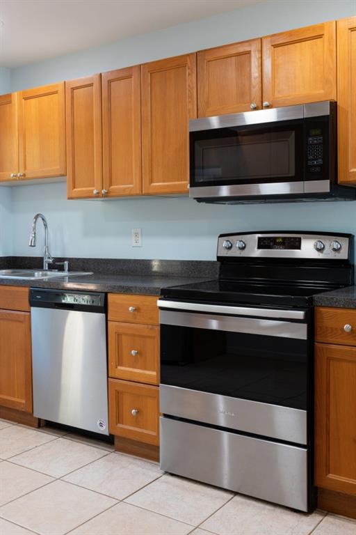 342 Mathews Avenue Northeast, Unit A Atlanta, GA 30307 - Photo 11 of 34 a kitchen with a stove and a microwave