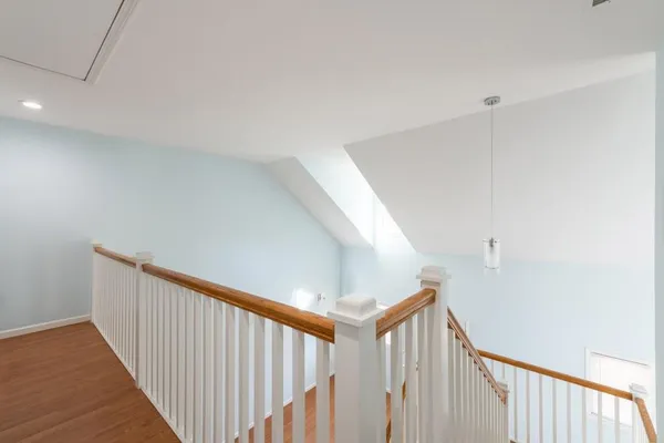 a view of a hallway with stairs