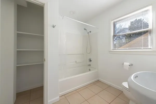 a white bath tub sitting next to a white toilet