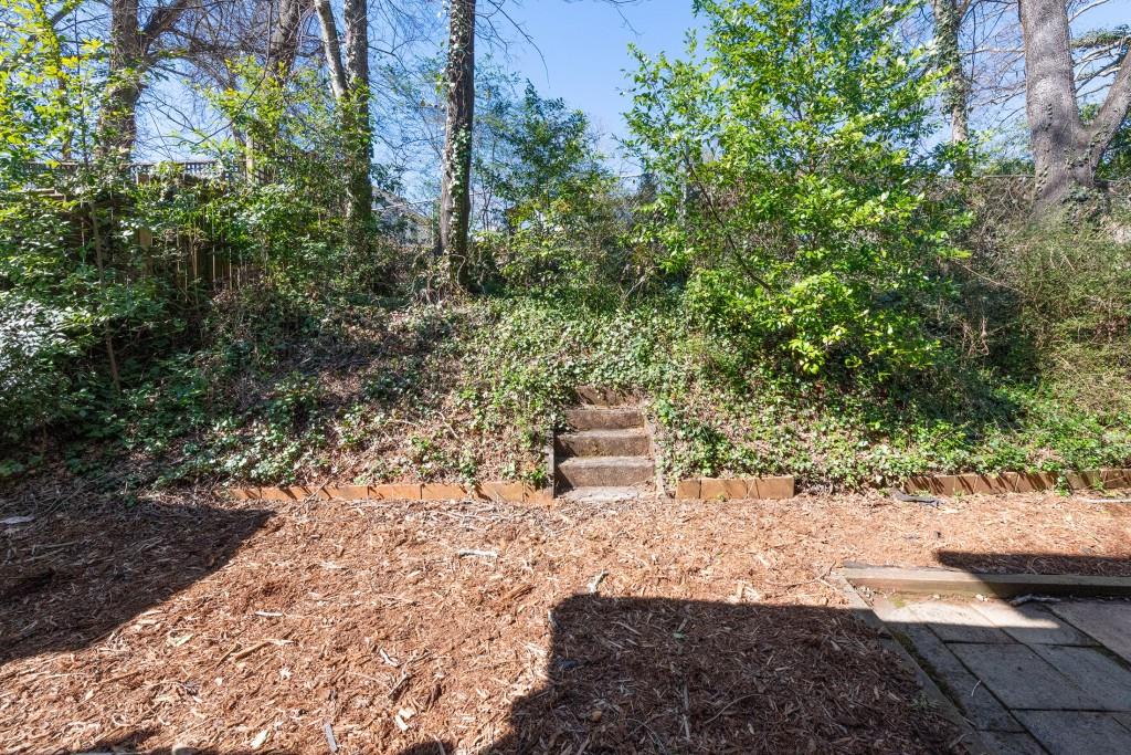 342 Mathews Avenue Northeast, Unit A Atlanta, GA 30307 - Photo 28 of 34 a bench sitting in the middle of a forest