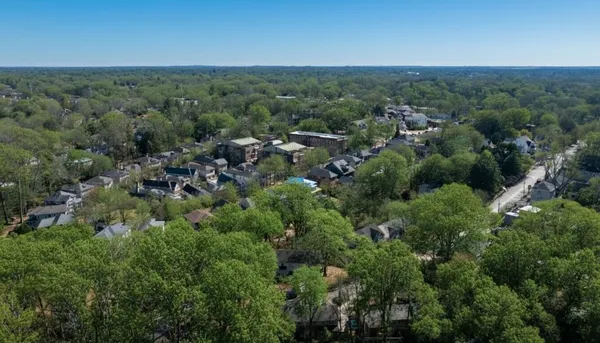 an aerial view of a houses with a yard