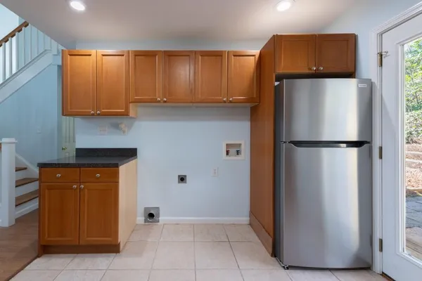 a kitchen with refrigerator and cabinets