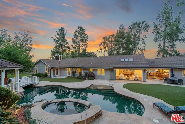 an outdoor view of house with swimming pool and outdoor seating