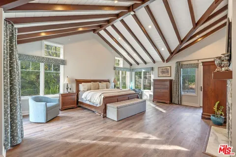 a spacious bedroom with a bed and a large window