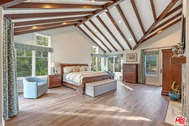 a spacious bedroom with a bed and a large window