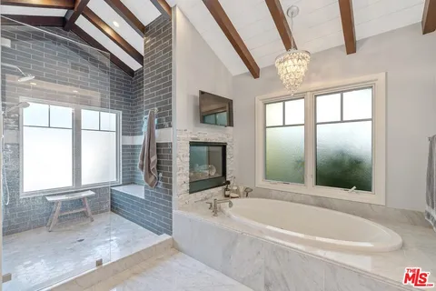 a bathroom with a bathtub and a shower