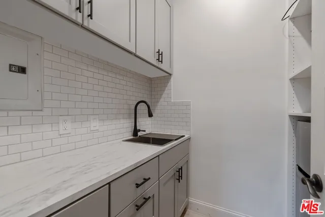 a kitchen with a sink and cabinets