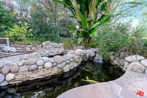 an aerial view of a house with outdoor space pool seating area and yard