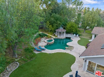 an aerial view of house with yard