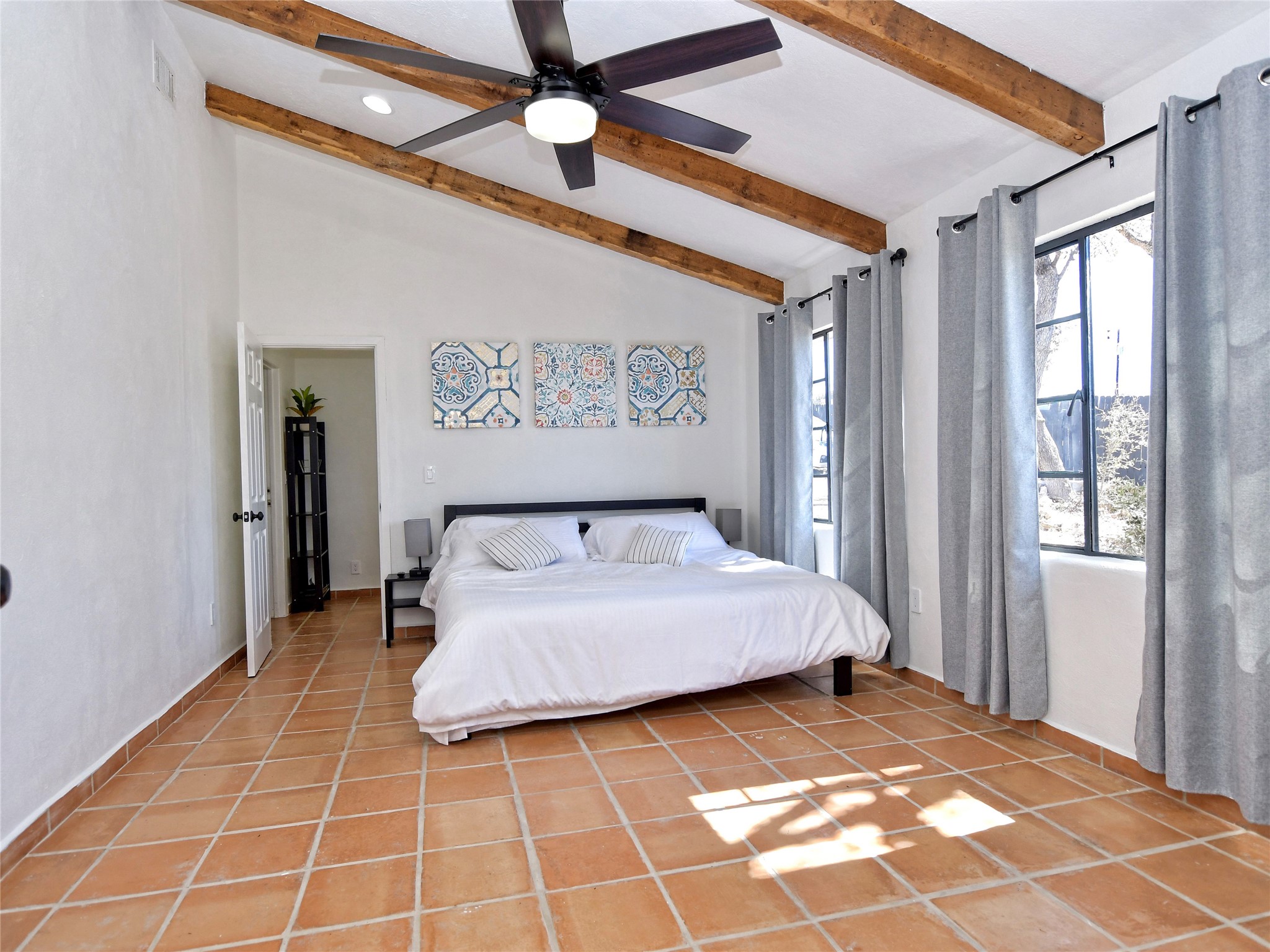 17123 Rocky Ridge Road Austin, TX 78734 - Photo 16 of 26 Vaulted ceiling with exposed wood beams and a ceiling fan