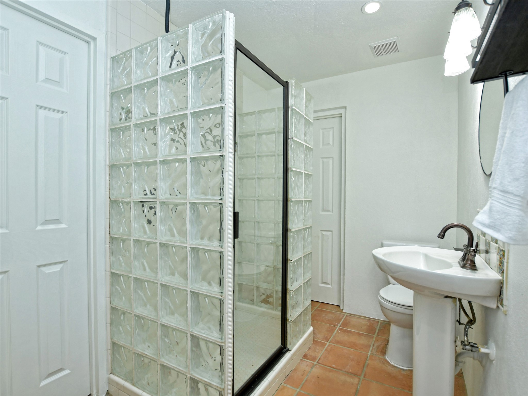 17123 Rocky Ridge Road Austin, TX 78734 - Photo 21 of 26 Shower enclosure featuring glass block construction and a framed glass door