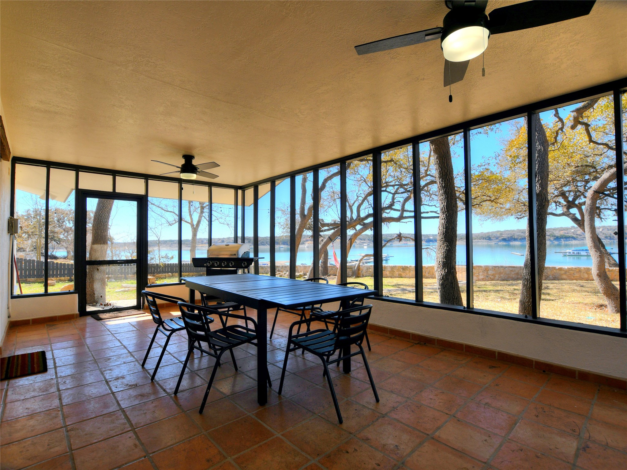 17123 Rocky Ridge Road Austin, TX 78734 - Photo 5 of 26 Screened-in porch featuring expansive windows and terracotta tile flooring