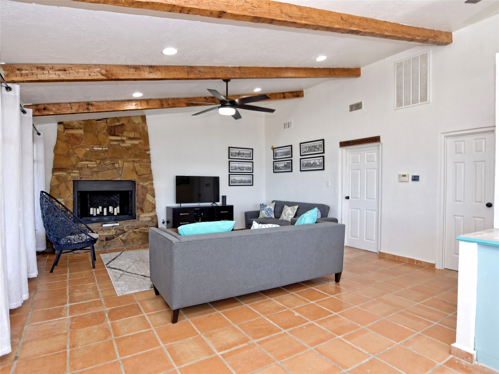 17123 Rocky Ridge Road Austin, TX 78734 - Photo 10 of 26 Living area with a stone-clad fireplace and hearth
