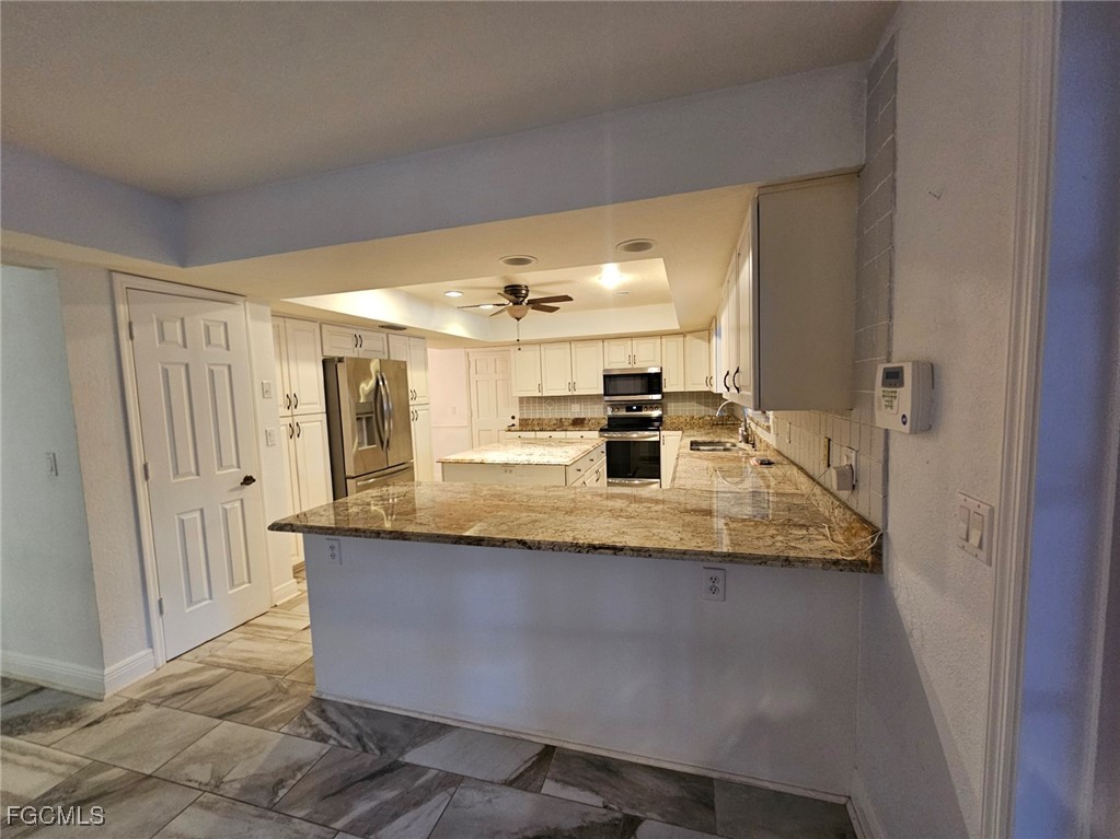 3680 Fort Denaud Road LaBelle, FL 33935 - Photo 19 of 49 a kitchen with stainless steel appliances granite countertop a sink and a refrigerator