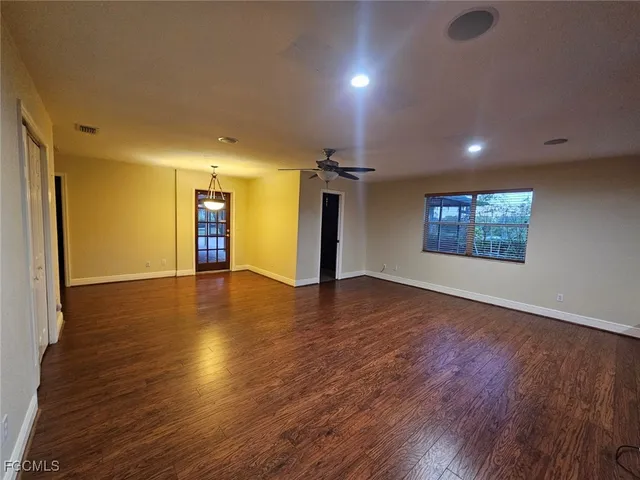 a view of a balcony with chairs and wooden floor