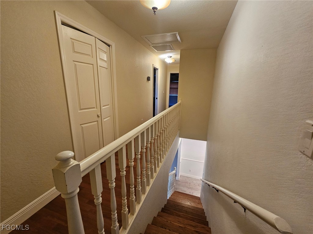 3680 Fort Denaud Road LaBelle, FL 33935 - Photo 31 of 49 a view of a hallway with wooden floor and staircase