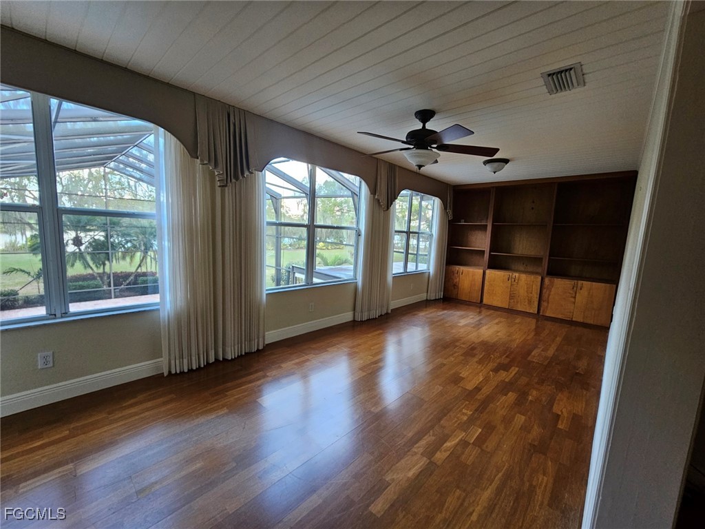 3680 Fort Denaud Road LaBelle, FL 33935 - Photo 33 of 49 wooden floor in an empty room with a window
