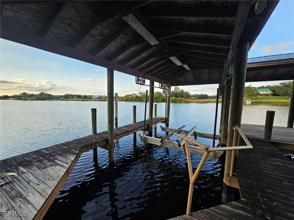 3680 Fort Denaud Road LaBelle, FL 33935 - Photo 42 of 49 a view of a balcony with chairs and wooden floor next to a yard