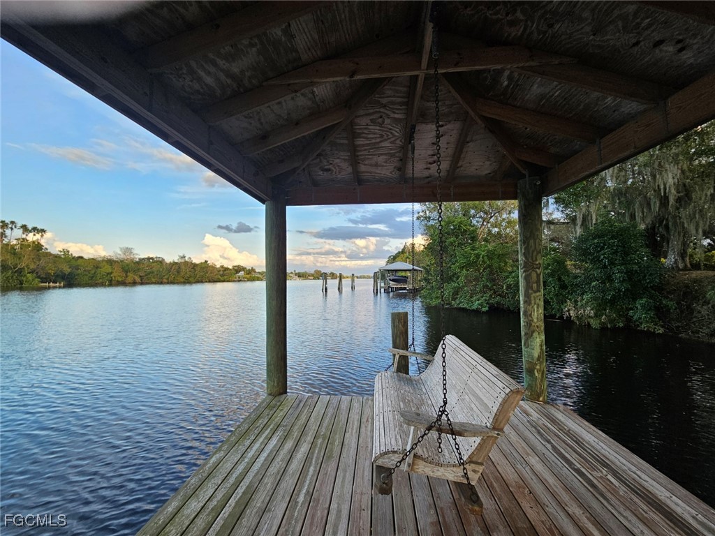 3680 Fort Denaud Road LaBelle, FL 33935 - Photo 45 of 49 a view of a balcony with lake view and wooden floor