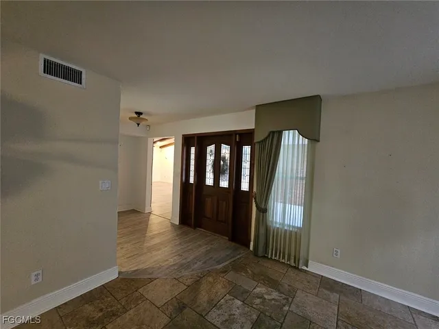 a kitchen with stainless steel appliances granite countertop a sink and a refrigerator
