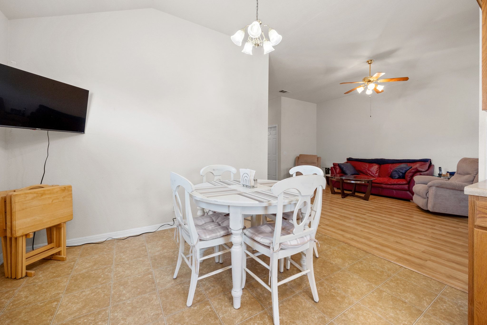 901 Kenneys Way Round Rock, TX 78665 - Photo 14 of 33 Dining area with lofted ceiling, a chandelier, ceiling fan, and light tile patterned floors