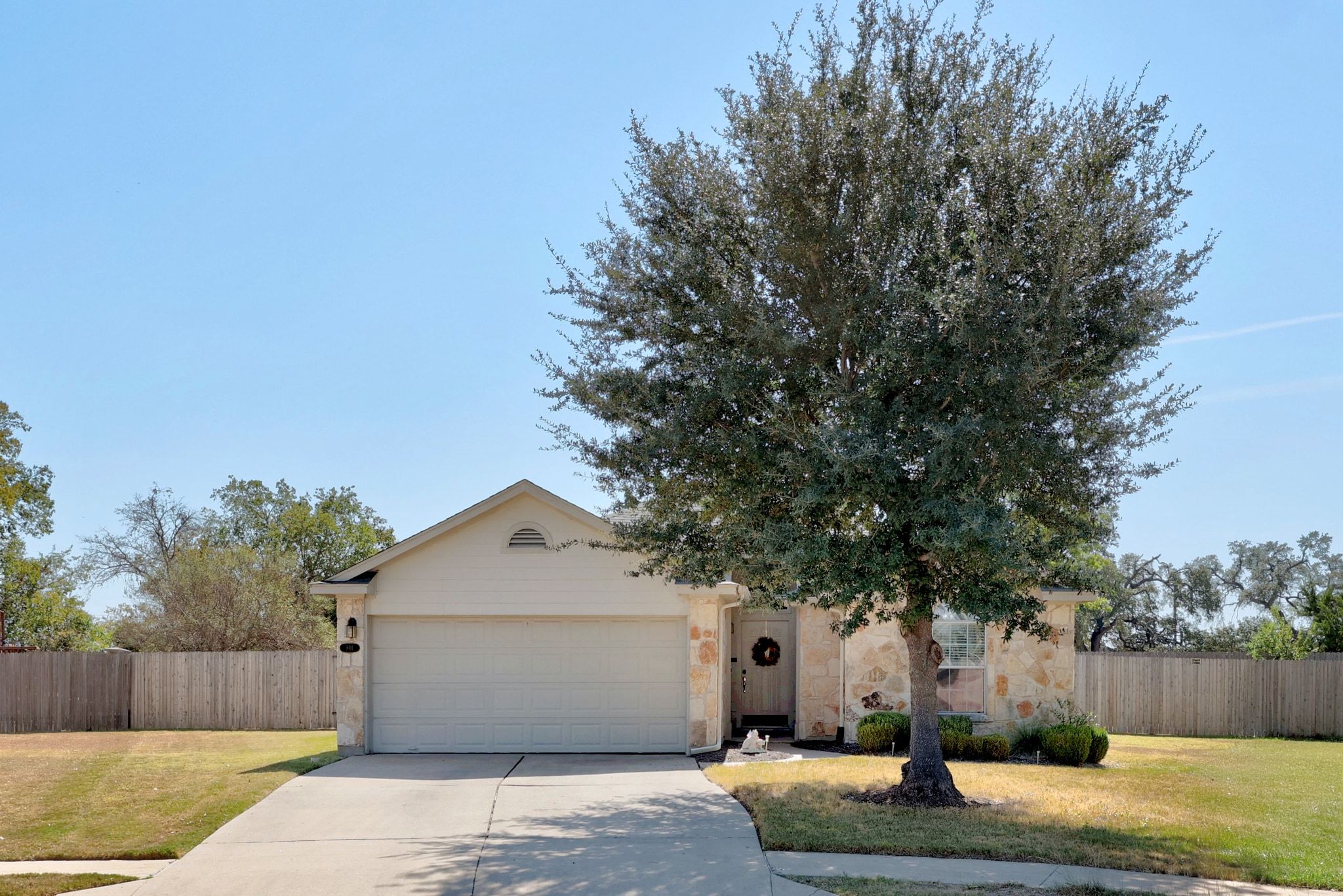 901 Kenneys Way Round Rock, TX 78665 - Photo 2 of 33 View of front of home featuring driveway, an attached garage, and stone siding