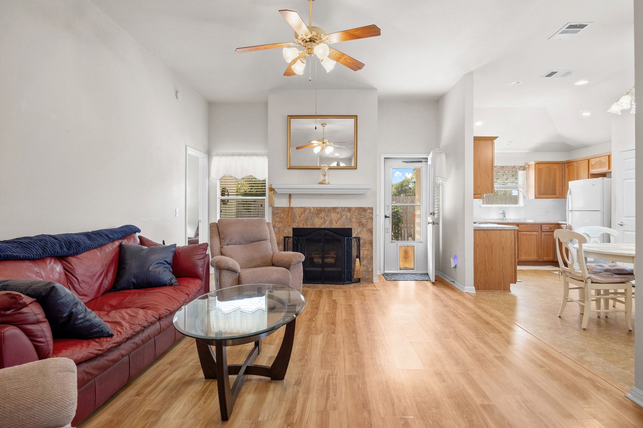 901 Kenneys Way Round Rock, TX 78665 - Photo 7 of 33 Living area with a fireplace, light wood-style flooring, ceiling fan, recessed lighting, and lofted ceiling