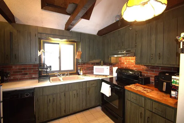 a kitchen with a sink stove and cabinets