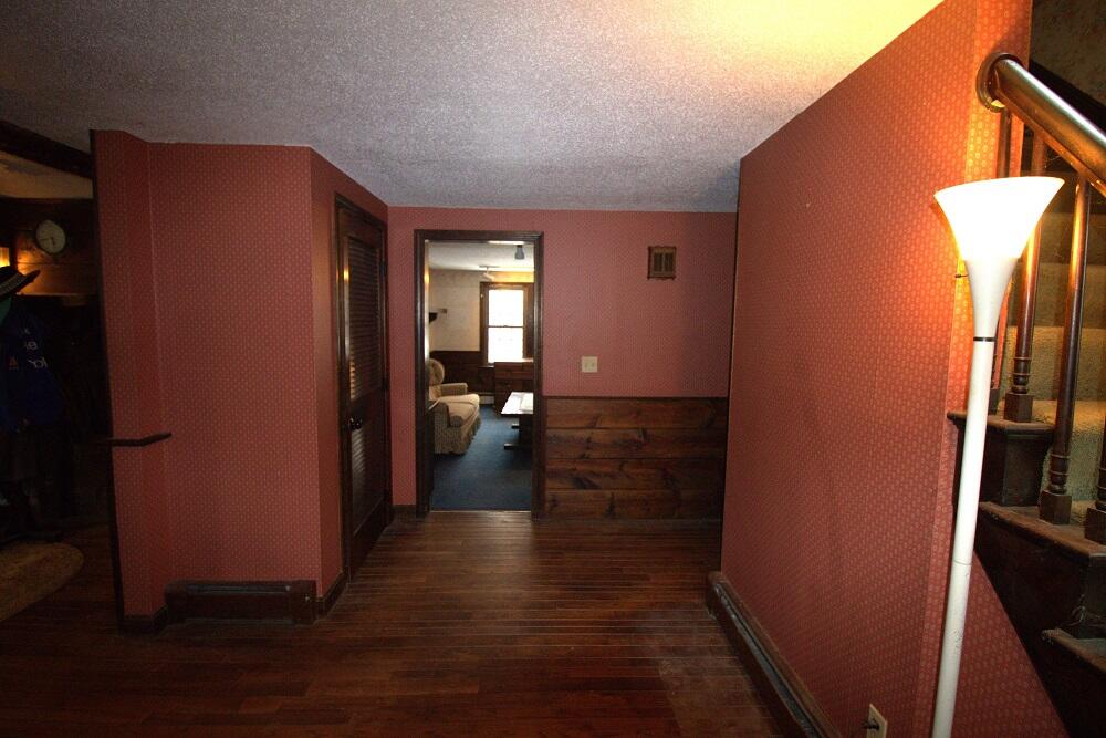 930 Old Bass River Road Dennis, MA 02638 - Photo 23 of 34 a view of a hallway with wooden floor and a living room
