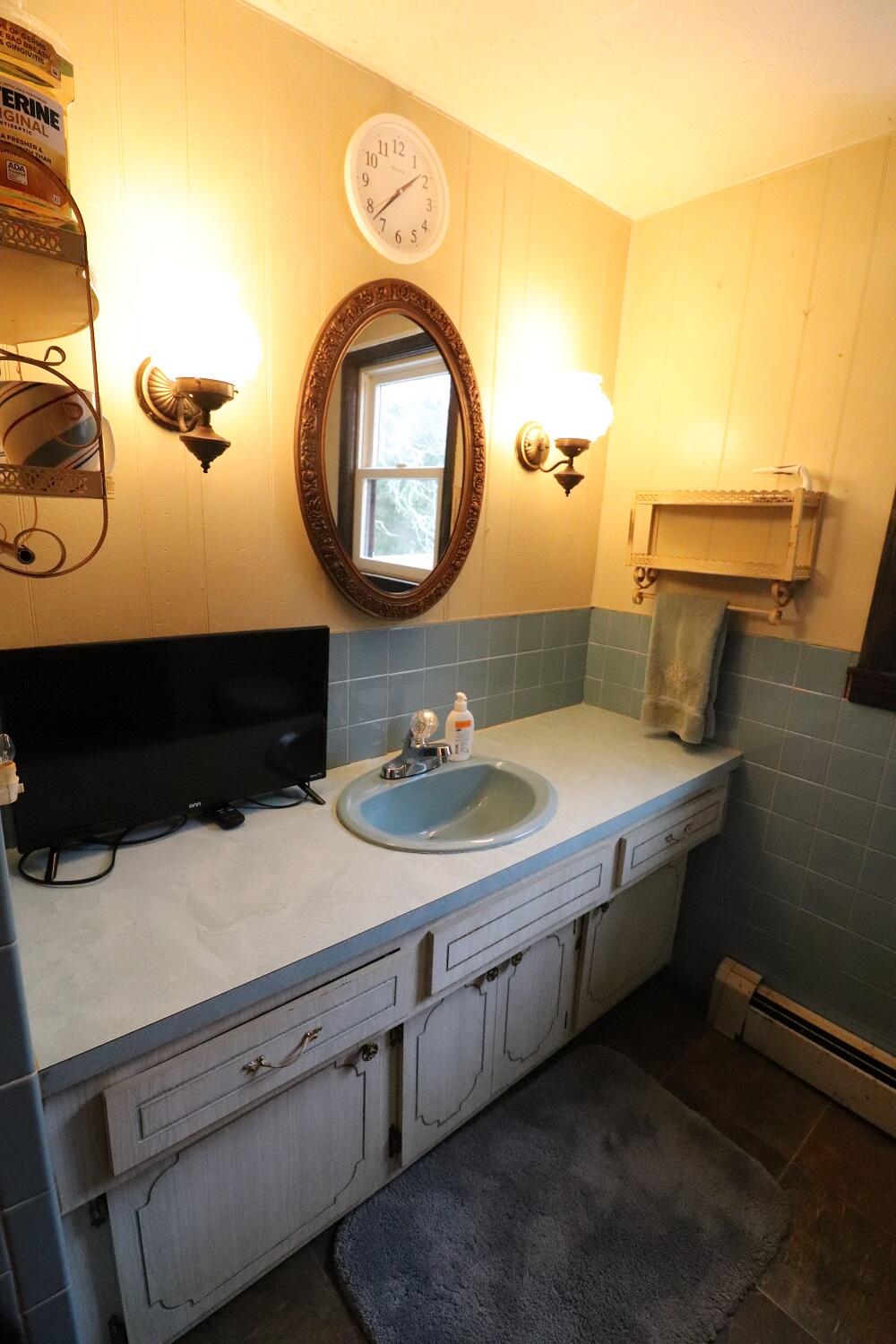 930 Old Bass River Road Dennis, MA 02638 - Photo 26 of 34 a bathroom with a sink and a mirror
