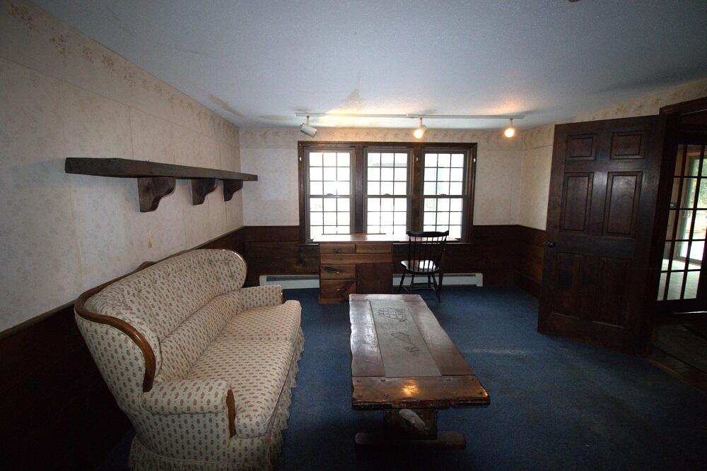 930 Old Bass River Road Dennis, MA 02638 - Photo 8 of 34 a living room with furniture and a floor to ceiling window