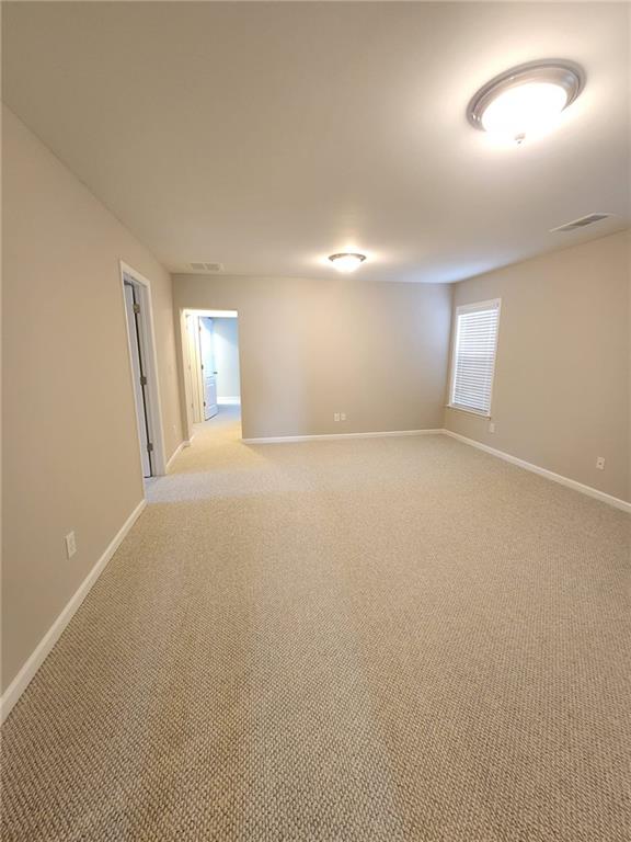 5520 Casey Valley Way Cumming, GA 30040 - Photo 12 of 25 en empty room with windows and closet
