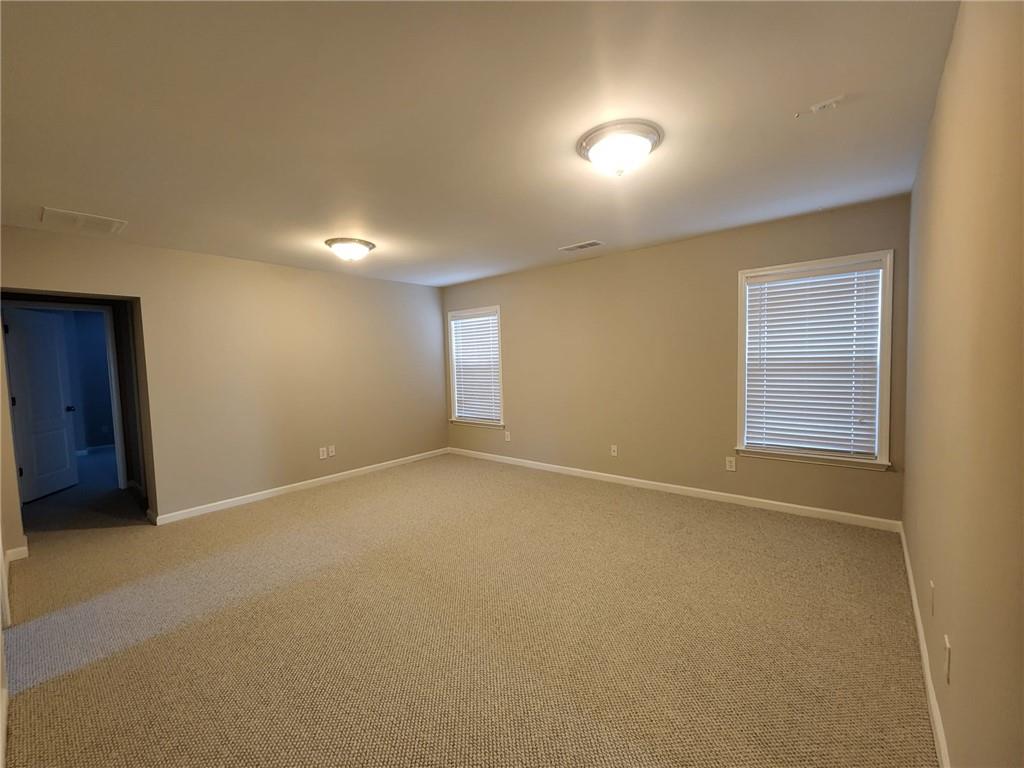 5520 Casey Valley Way Cumming, GA 30040 - Photo 22 of 25 an empty room with a empty space and windows