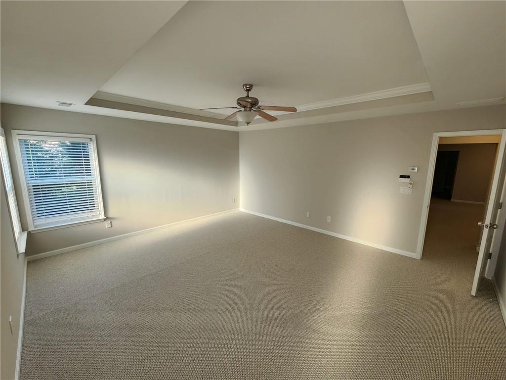 5520 Casey Valley Way Cumming, GA 30040 - Photo 23 of 25 an empty room with windows and fan