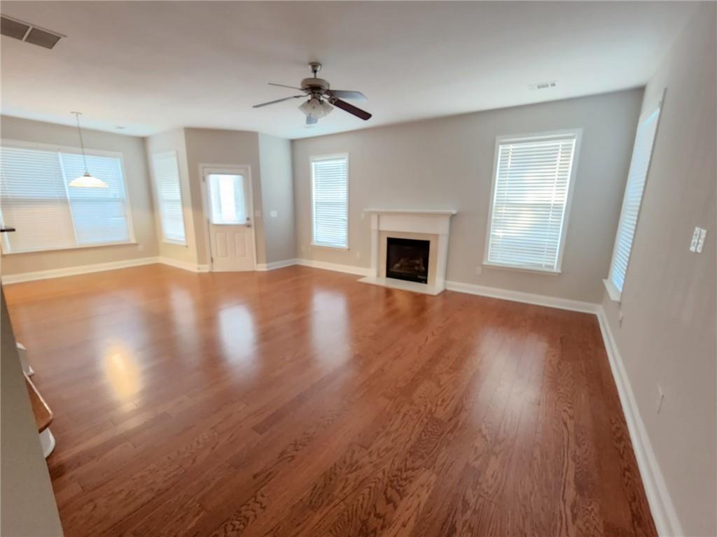 5520 Casey Valley Way Cumming, GA 30040 - Photo 7 of 25 a view of empty room with wooden floor and fan