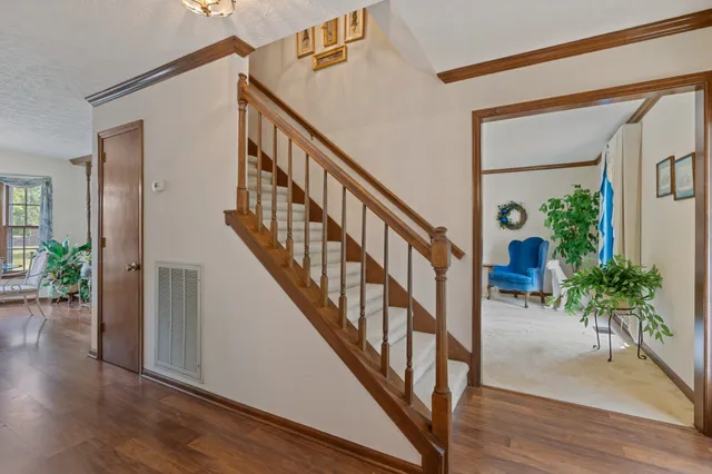 an empty room with a fireplace and painted walls