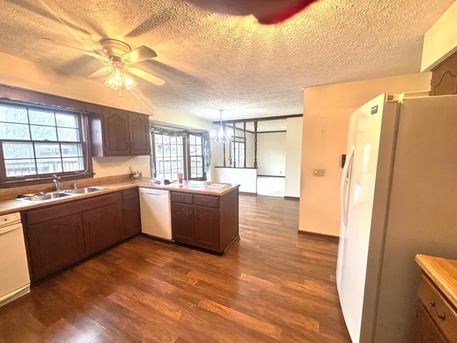 a bathroom with a sink a toilet and a window