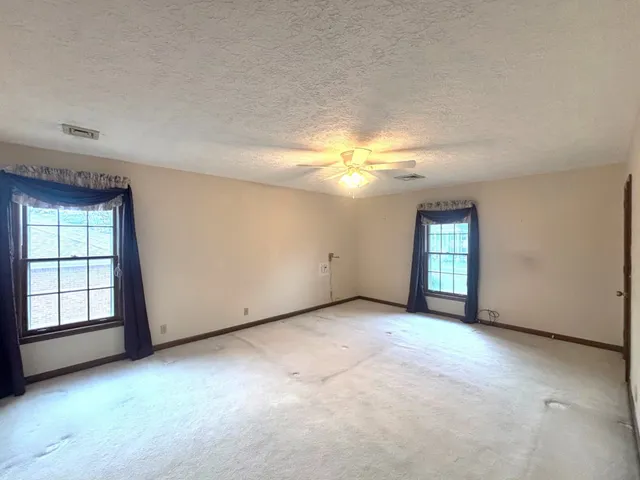 a bedroom with a bed and a potted plant