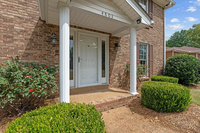 a view of an entryway with wooden floor and door